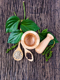 Close-up of spice with mortar and pestle on wooden table