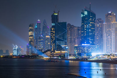 Illuminated buildings in city at night