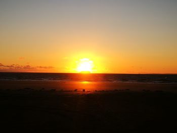 Scenic view of sea against romantic sky at sunset