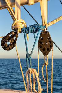 Close-up of sailboat in sea against clear sky