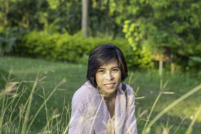 Portrait of smiling young woman on field