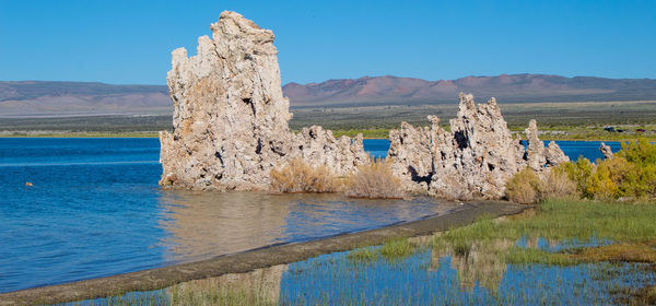 Scenic view of lake against clear blue sky