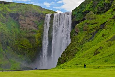 Scenic view of waterfall against sky