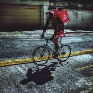 Man riding bicycle on street in city