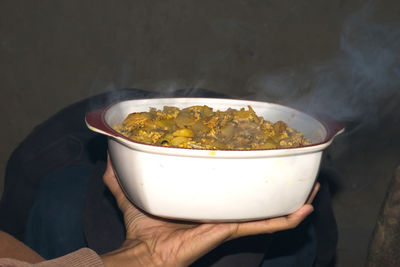 Close-up of hand holding bowl