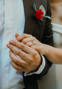 Midsection of couple holding hands