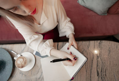 High angle view of woman preparing food on table