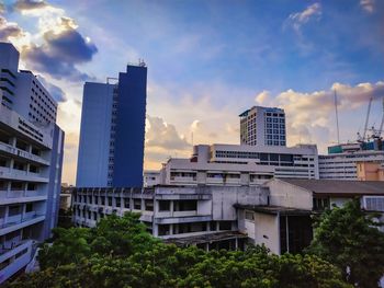 Low angle view of buildings against sky during sunset