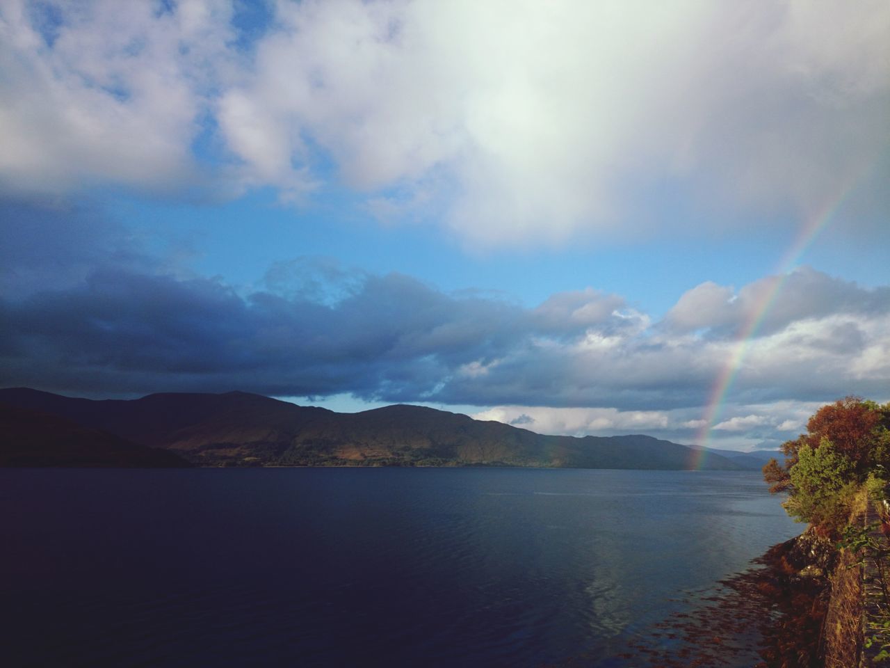 water, tranquil scene, sky, scenics, mountain, tranquility, beauty in nature, cloud - sky, mountain range, lake, nature, cloudy, cloud, idyllic, waterfront, reflection, non-urban scene, river, sea, calm