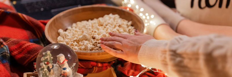 Female hand eat popcorn food and enjoyment relaxing watching movie