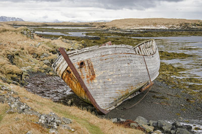 Wreck of an old wooden boat on a small beach in iceland