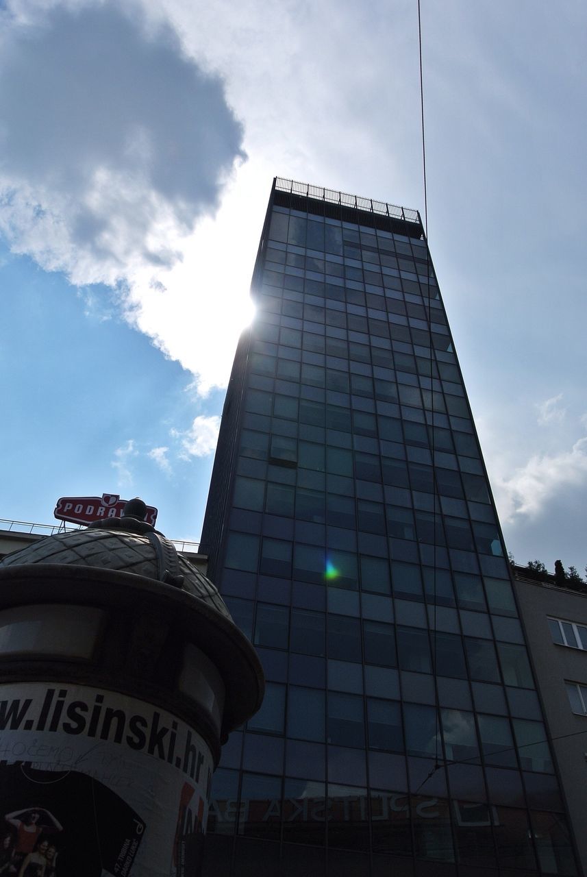 low angle view, architecture, building exterior, built structure, sky, tower, city, tall - high, cloud - sky, skyscraper, communication, modern, office building, cloud, day, text, glass - material, cloudy, western script, no people