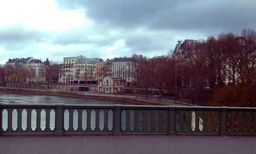 Buildings against cloudy sky