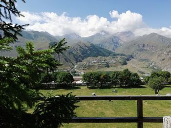 Scenic view of landscape and mountains against sky