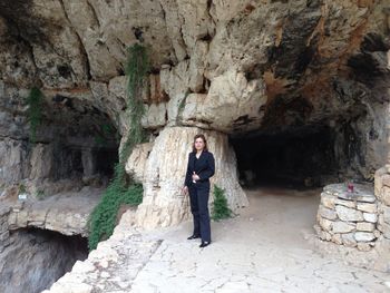 Portrait of woman standing on rock