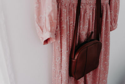 Close-up of pink hanging against wall