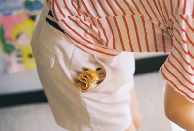 Midsection of woman with handkerchief in pocket outdoors