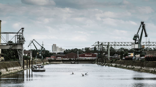 View of harbor against cloudy sky