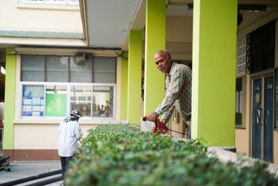 Young man standing by building