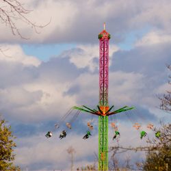 Low angle view of amusement park ride against sky