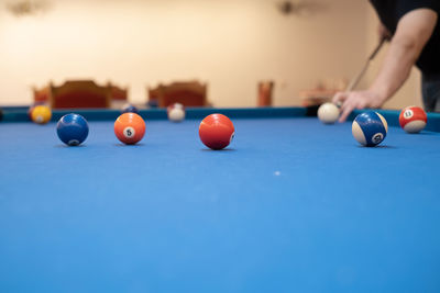 Cropped hand playing pool