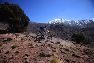 Scenic view of mountains against blue sky