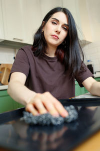 Portrait of young woman using mobile phone