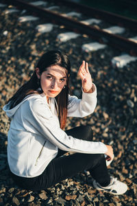 Portrait of young woman sitting outdoors