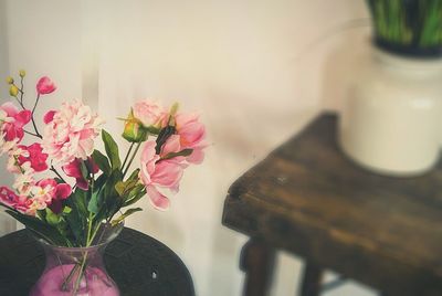 Pink flowers in vase on table at home
