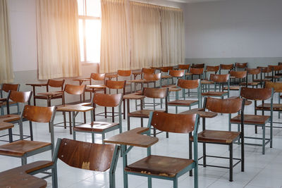 Empty chairs and tables in classroom