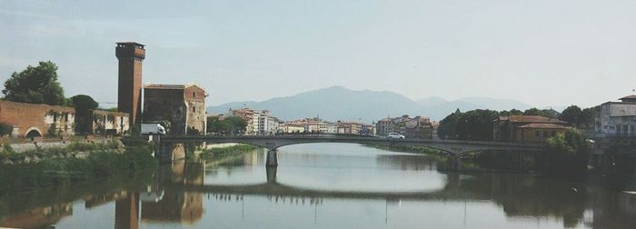 Bridge over river with buildings in background