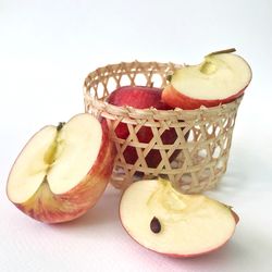 Close-up of apple on table against white background