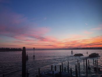 Pier on sea at sunset