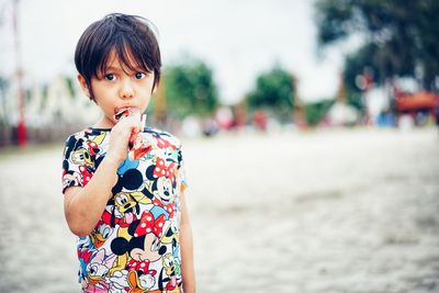 Portrait of cute boy standing outdoors