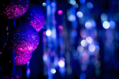 Close-up of christmas decorations against defocused background at night