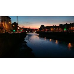 Boats in river at sunset