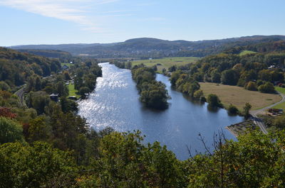 Scenic view of river amidst trees against sky