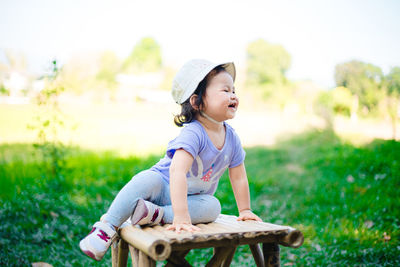 Cute girl sitting on field