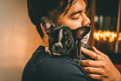 Close-up of man holding puppy