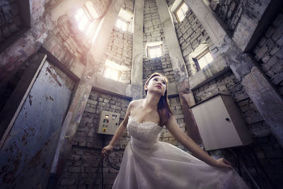Low angle view of woman with umbrella