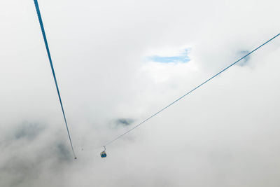 Overhead cable car amidst clouds