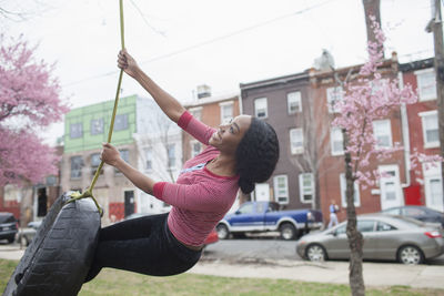 Woman on tire swing.