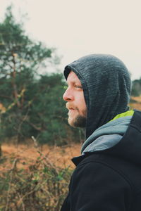 Close-up of man standing against trees