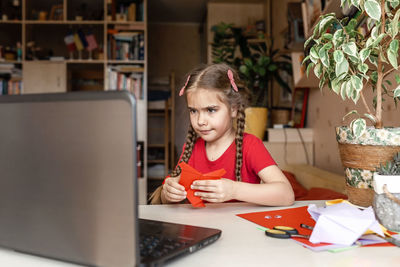 Girl holding origami at home