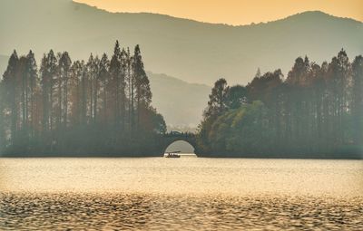 Scenic view of river and mountains against sky