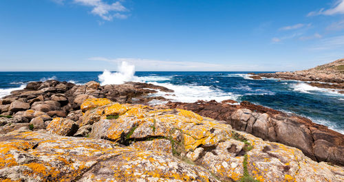 Scenic view of rocks in sea against sky