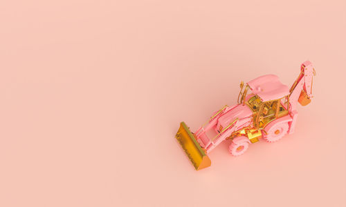 High angle view of small toy against pink background
