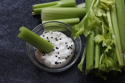 High angle view of vegetables with dip in bowl