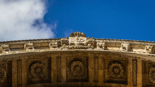 Low angle view of historical building against blue sky