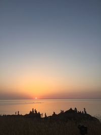 Scenic view of sea against clear sky during sunset